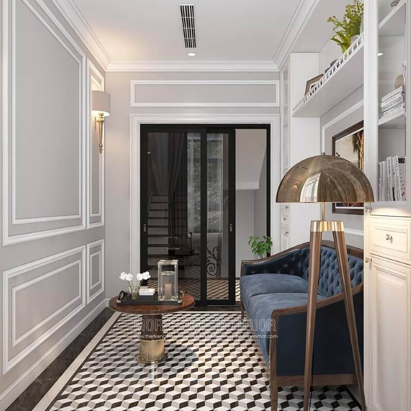 Gạch lát nền giả cổ, sofa văng gỗ óc chó tân cổ điển bọc nệm xanh cùng tường trắng đơn sắc đã tạo nên không gian đẹp sang trọng, đáp ứng tối đa công năng cho phòng đọc sách. thiết kế biệt thự tân cổ điển