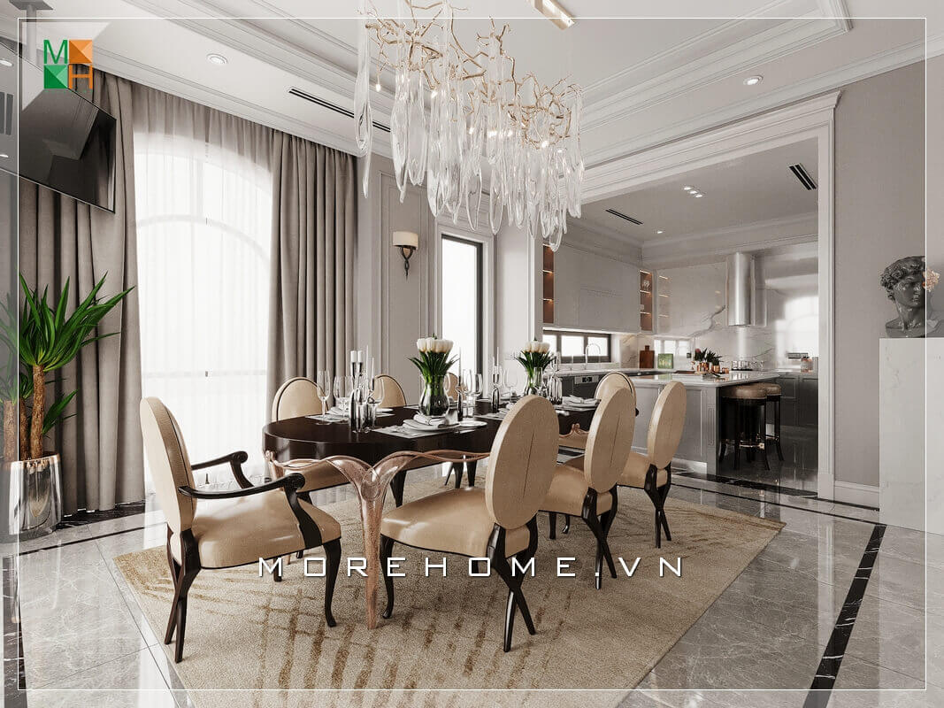Thiết kế không gian phòng bếp liền phòng ăn rất rộng rãi và thoáng mát, sử dụng đèn chùm treo giữa không gian bàn ăn mang đậm chút tân cổ điện rất đẳng cấp. Thi công nội thất biệt thự